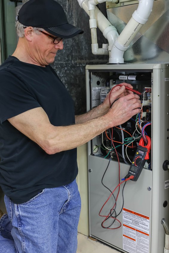 HVAC technician working on a furnace.