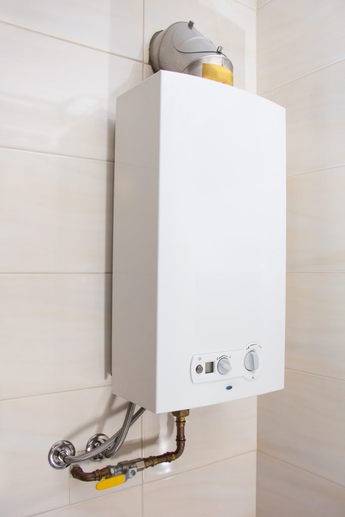 white tankless water heater installed in bathroom